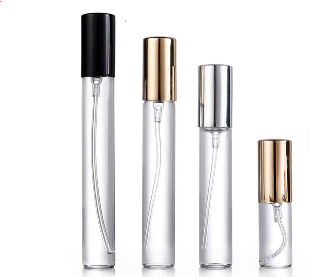 Set of clear perfume bottles with black, gold, and silver caps on a white background